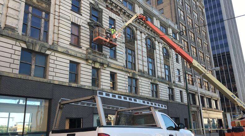 Crews work on the Ludlow Street side of the Dayton Arcade. CORNELIUS FROLIK / STAFF