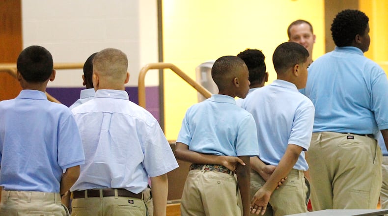 Dayton Boys Prep Academy students wait in line for a trip to the cafeteria on the first day of the 2018-2019 school year. TY GREENLEES / STAFF