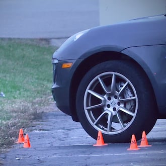 A vehicle with evidence markers near its front wheel after a shooting incident in the Sportsplex parking lot near Dayton Road on Sunday, Nov. 30, 2025 in Fairborn. MARSHALL GORBY / CONTRIBUTED PHOTO