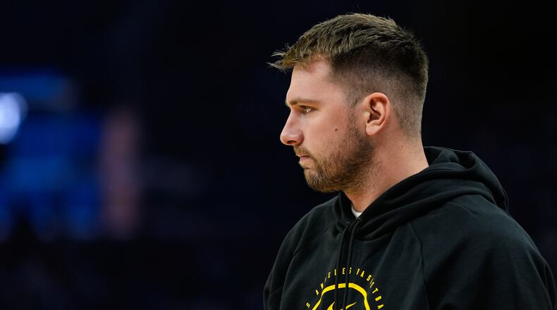 Los Angeles Lakers' Luka Dončić stands on the court during a timeout in the first half of an NBA basketball preseason game against the Golden State Warriors, Sunday, Oct. 5, 2025, in San Francisco. (AP Photo/Godofredo A. Vásquez)
