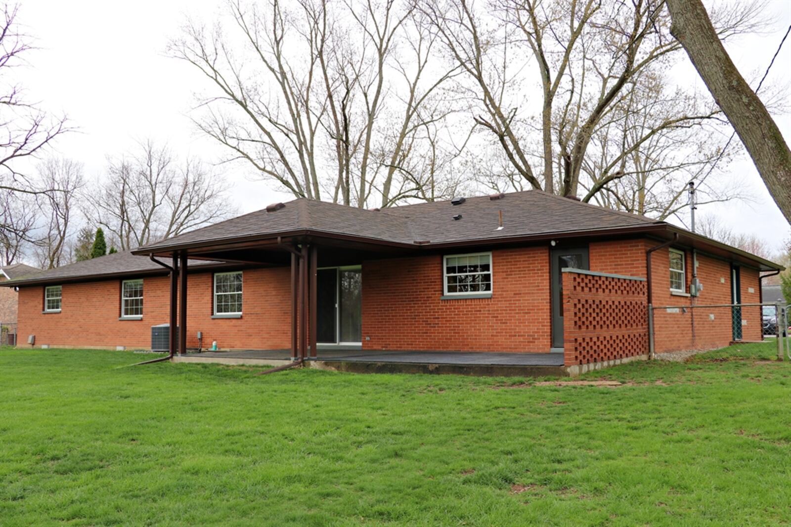Across the back of the home is a large covered porch with an extended sun patio that is semi-private. 