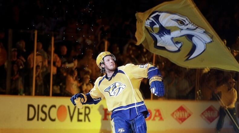 Nashville Predators center Ryan Johansen throws a T-shirt into the crowd after as was introduced as the first star of the game after the Predators beat the St. Louis Blues in Game 6 of a second-round NHL hockey playoff series Sunday, May 7, 2017, in Nashville, Tenn. The Predators won 3-1 to win the series 4-2. (AP Photo/Mark Humphrey)