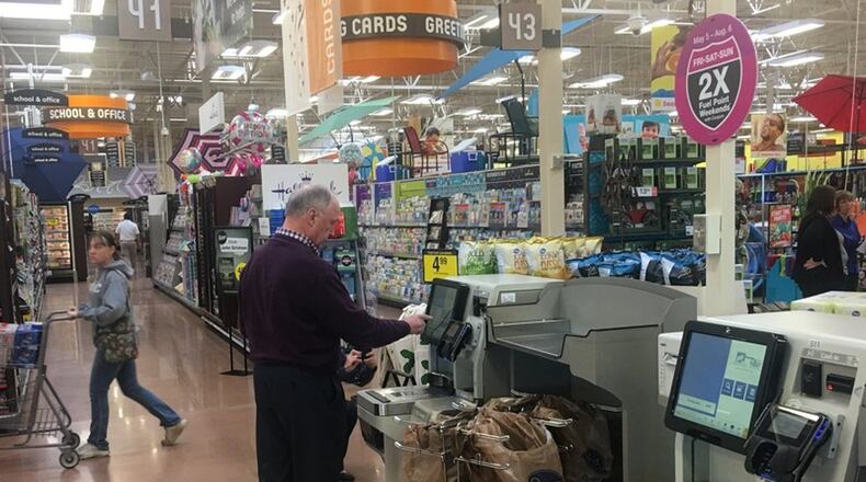 A customer uses self checkout at a Kroger store in the Dayton region. KARA DRISCOLL/STAFF