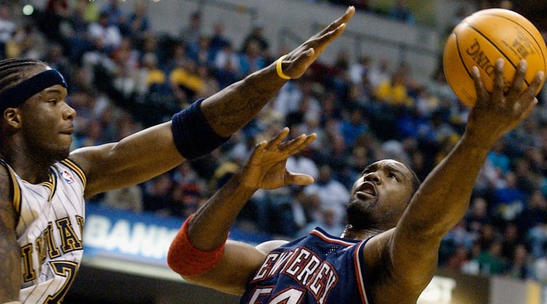 FILE - New Jersey Nets forward Rodney Rogers puts up a shot against Indiana Pacers forward Jermaine O'Neal during the first quarter of a basketball game in Indianapolis, April 9, 2004. (AP Photo/Darron Cummings, File)