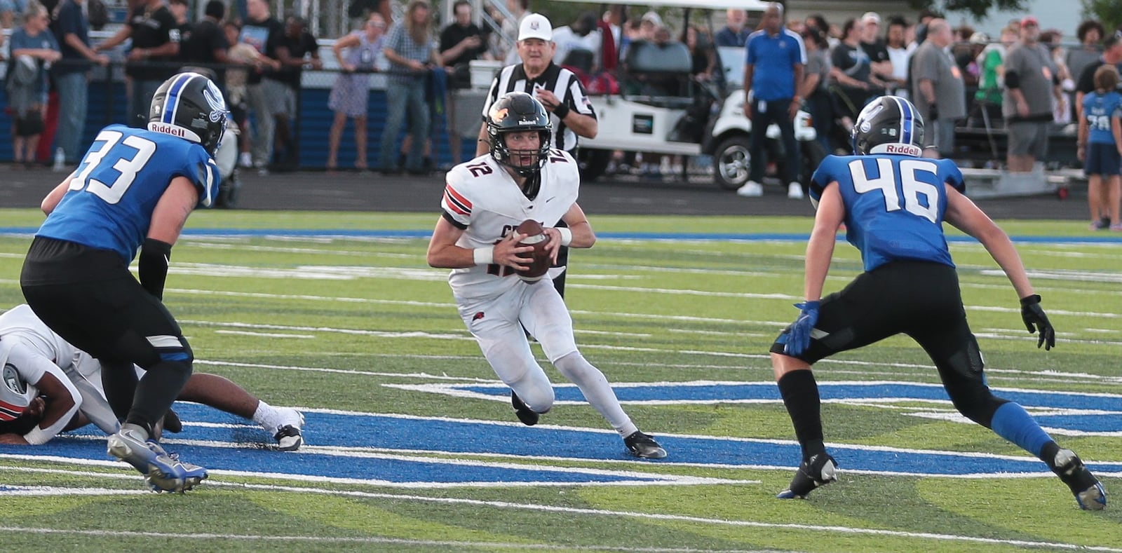Beavercreek quarterback Jack Minnick looks for an opening as Xenia's Cecil Piner (33) and Cam Salyers close in during a game Friday, Aug. 22, 2025, at Doug Adams Stadium in Xenia. Steve Black / Staff