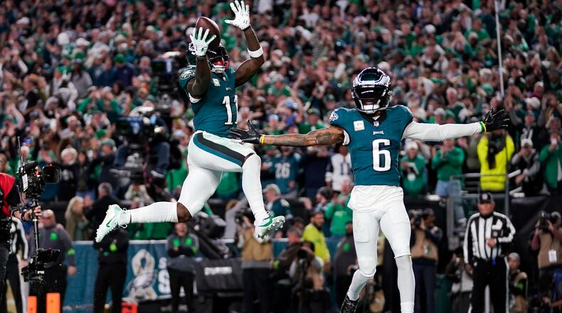 Philadelphia Eagles wide receiver A.J. Brown (11) and Eagles' DeVonta Smith (6) celebrate a touchdown by Brown during the second half of an NFL football game Sunday, Nov. 5, 2023, in Philadelphia. (AP Photo/Matt Slocum)