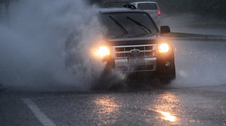 Montgomery County received over two inches of rainfall on Wednesday morning. On James H. McGee Blvd. in Dayton, this car deals with the massive puddles. MARSHALL GORBY/STAFF