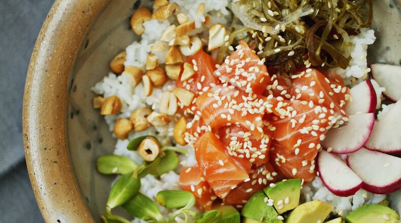 You can make your own poke bowls at home. Get the right ingredients, do a little chopping, and you have a simple, satisfying meal. You can even throw a poke party and let guests fill their bowls with the base, fish, toppings and sauce they prefer. (Juli Leonard/Raleigh News & Observer/TNS)