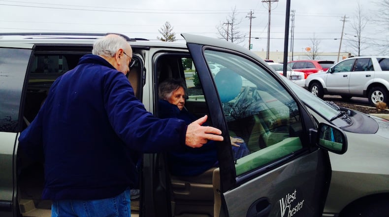 Gene Hendel, a volunteer driver for the West Chester Twp. senior transportation program helps 82-year-old Rita Penny into the van at the Senior Activity Center.