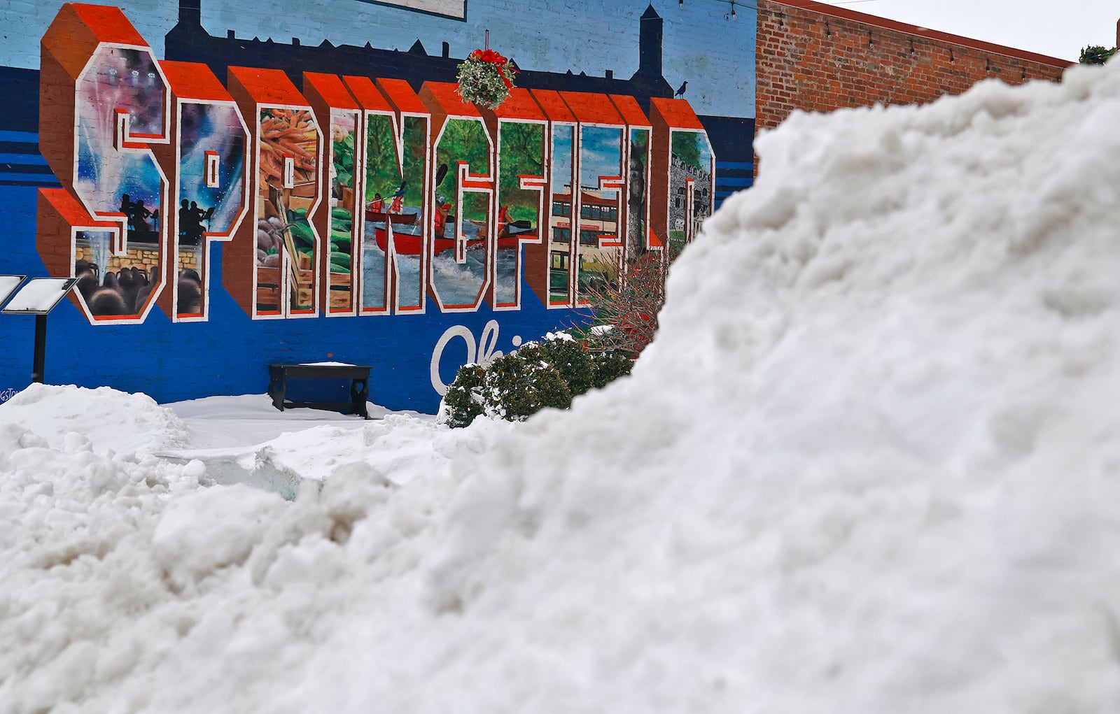 Snow is piled up in front the Greetings from Springfield mural along South Fountain Avenue Tuesday, Jan. 7, 2025. BILL LACKEY/STAFF