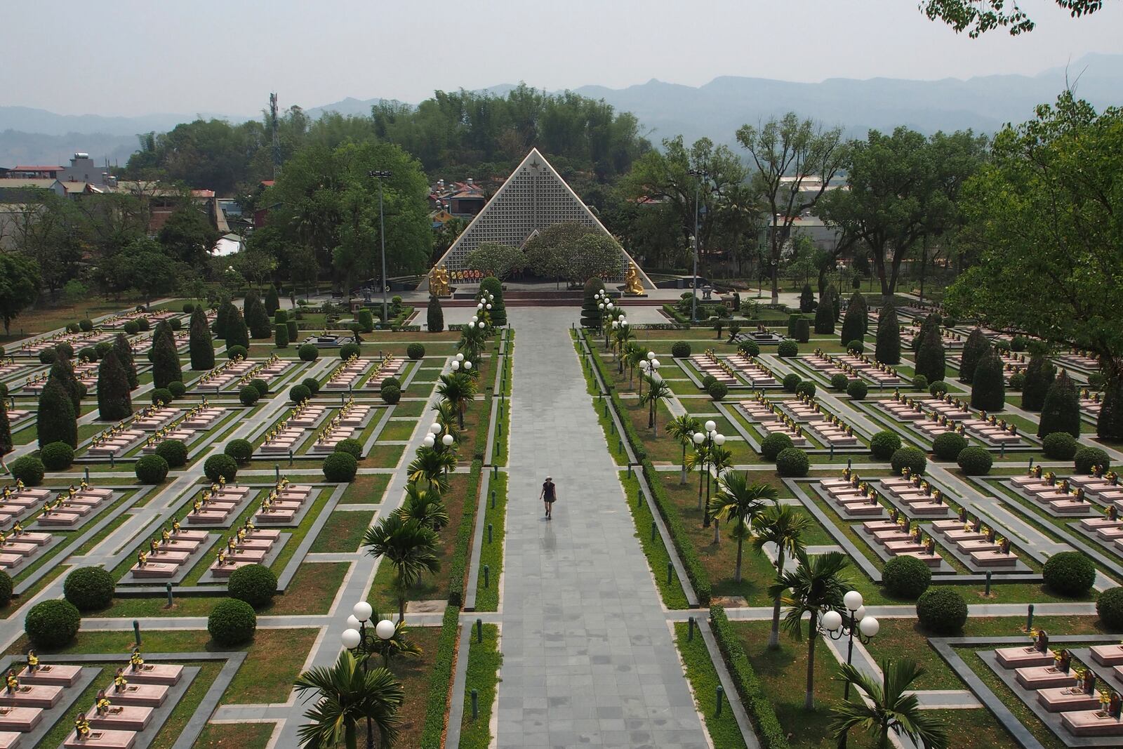 A tourist walks through the Dien Bien Phu Military Cemetery in Dien Bien Phu, Vietnam, April 22, 2019. (AP Photo/David Rising)