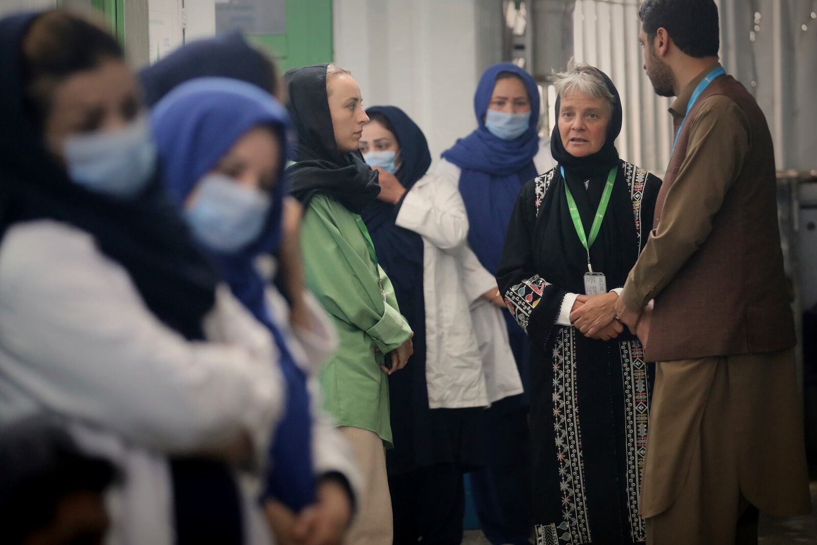 Action Against Hunger's country director Cobi Rietveld, second from right, talks to her staff at their therapeutic feeding unit in Kabul, Afghanistan, Tuesday, April 15, 2025. (AP Foto/Siddiqullah Alizai)