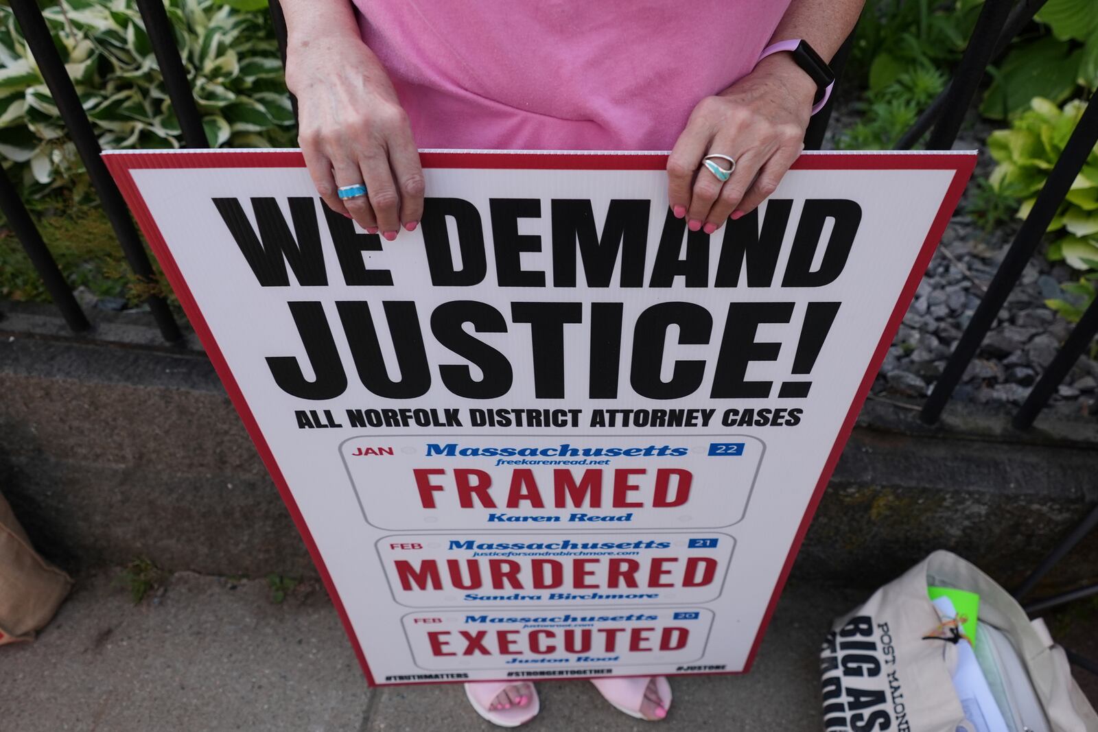 A supporter of Karen Read holds a sign prior to the day's session outside Norfolk Superior Court, Thursday, June 12, 2025, in Dedham, Mass. (AP Photo/Charles Krupa)