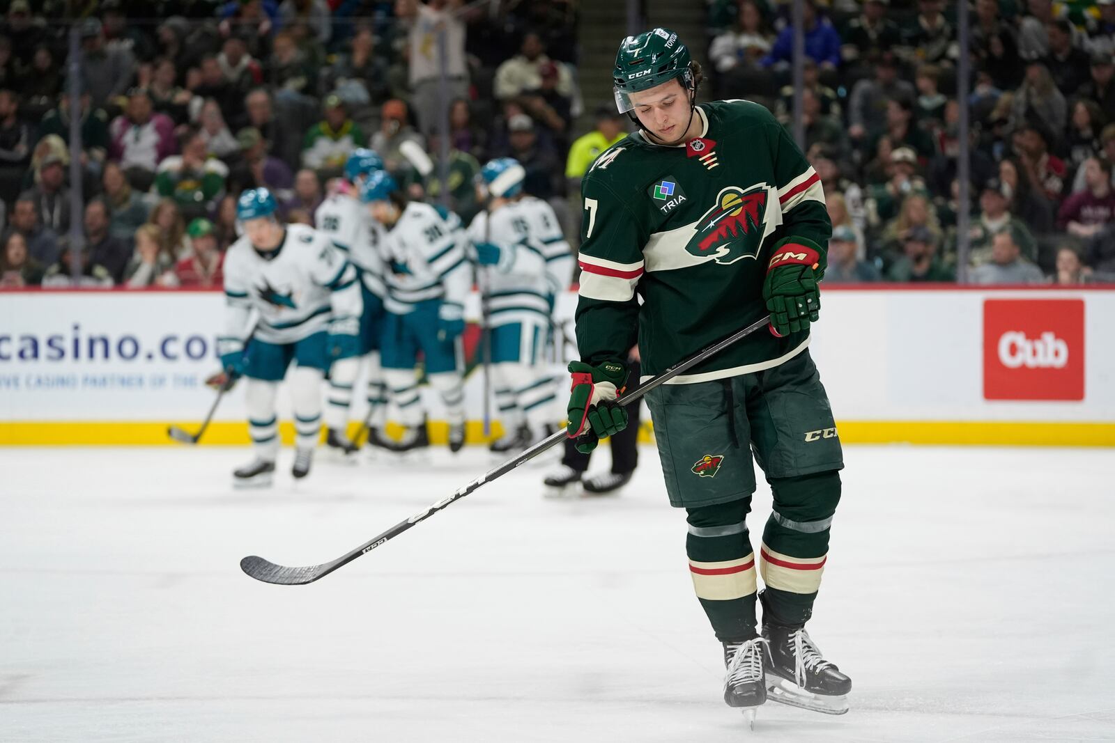 Minnesota Wild defenseman Brock Faber (7) skates after a goal scored by San Jose Sharks center Macklin Celebrini (71) during the second period of an NHL hockey game, Wednesday, April 9, 2025, in St. Paul, Minn. (AP Photo/Abbie Parr)