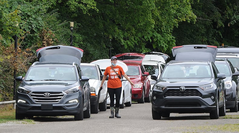 Hundreds of vehicles lined up on Tuesday Aug. 16, 2021, for the mass drive-through food distribution at the Dixie Twin Drive-In hosted by The Foodbank. MARSHALL GORBY\STAFF