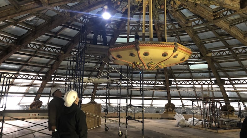 Dave Williams, senior development director with Cross Street Partners, examines the metal cornucopia in the center of the metal Dayton Arcade dome. The metal structure will be repainted, as will the 16 plaster turkeys around the dome. CORNELIUS FROLIK / STAFF
