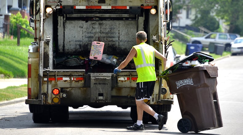 A Rumpke garbage truck picks up trash from a residence in. Bill Lackey/Staff