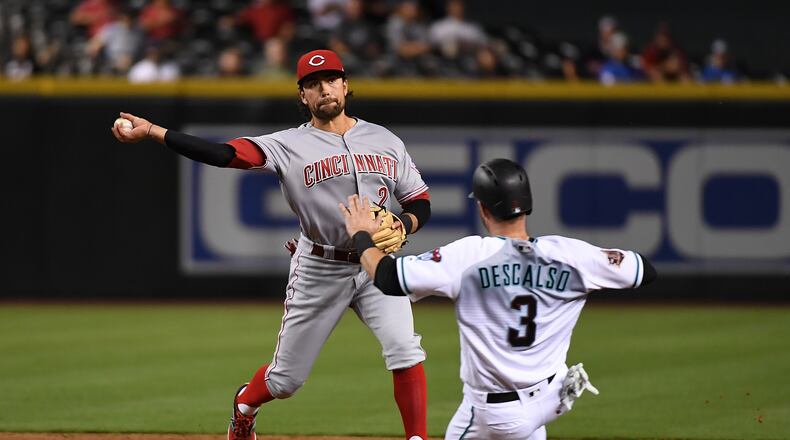 PHOENIX, AZ - MAY 29: Alex Blandino #2 of the Cincinnati Reds turns a double play as Daniel Descalso #3 of the Arizona Diamondbacks slides into second base during the third inning at Chase Field on May 29, 2018 in Phoenix, Arizona. (Photo by Norm Hall/Getty Images)
