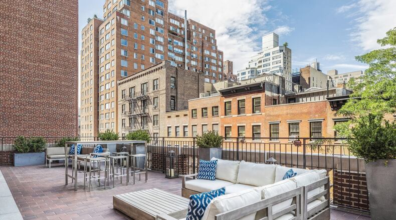 An outdoor space is divided into lounge and dining zones. (Design Recipes)