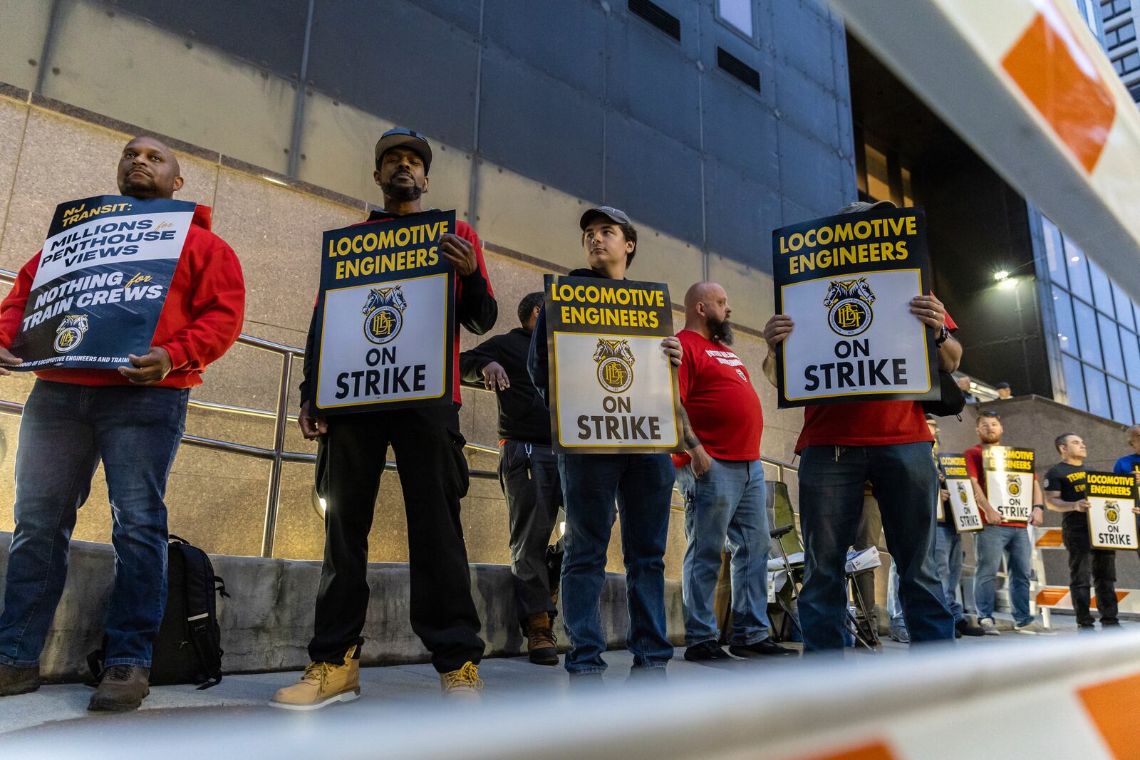 Union members from the Brotherhood of Locomotive Engineers and Trainmen form a picket line outside the NJ Transit Headquarters on Friday, May 16, 2025 in Newark, New Jersey. (AP Photo/Stefan Jeremiah)
