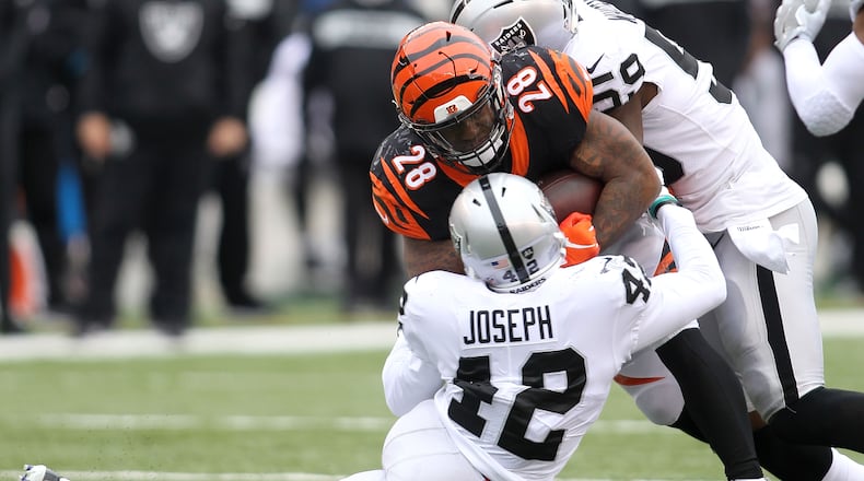CINCINNATI, OH - DECEMBER 16: Karl Joseph #42 of the Oakland Raiders and Tahir Whitehead #59 combine to tackle Joe Mixon #28 of the Cincinnati Bengals during the second quarter at Paul Brown Stadium on December 16, 2018 in Cincinnati, Ohio. (Photo by John Grieshop/Getty Images)