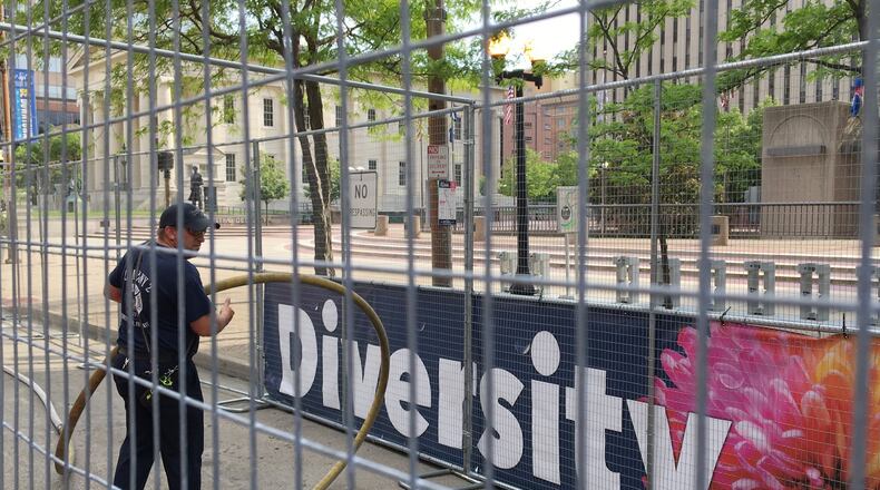 Dayton firefighters fill plastic barricades with water Friday inside a double fence that will separate counter protesters from a Ku Klux Klan-affiliated group with a permit to rally on Courthouse Square today in downtown Dayton. The city put banners around the square as part of its United Against Hate campaign. CHRIS STEWART / STAFF