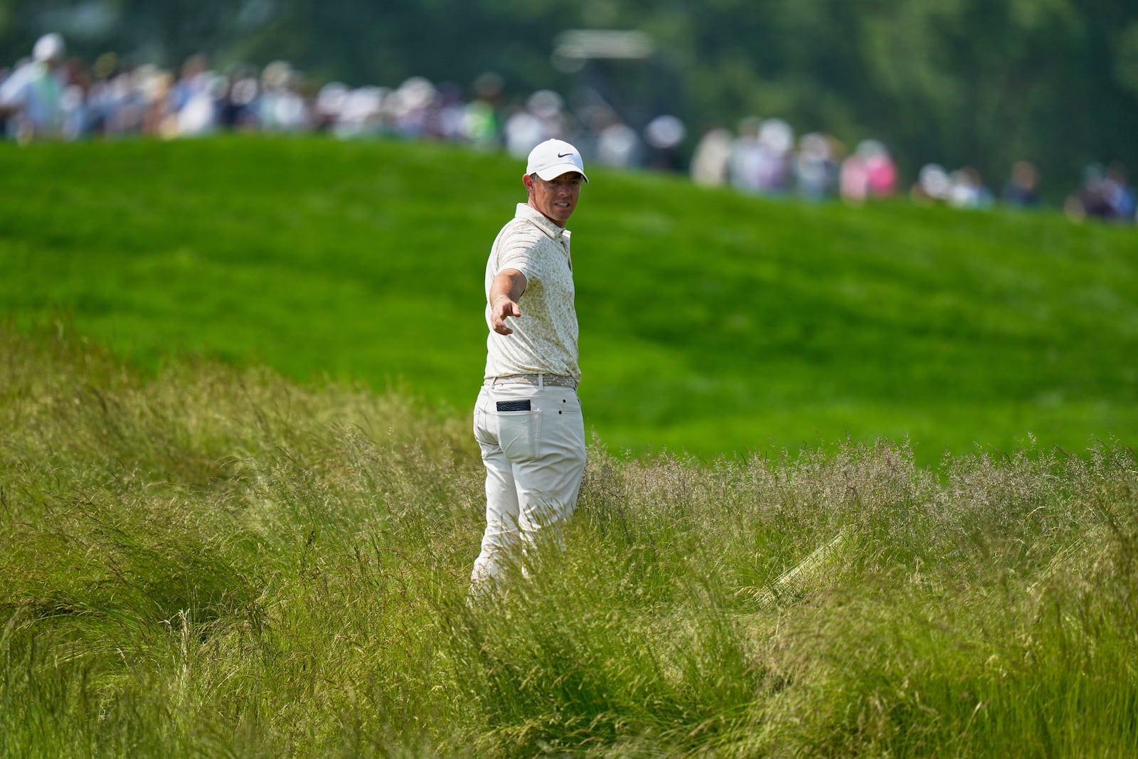 Rory McIlroy, of Northern Ireland, prepares to hit from the tall grass on the fourth hole during the first round of the U.S. Open golf tournament at Oakmont Country Club Thursday, June 12, 2025, in Oakmont, Pa. (AP Photo/Seth Wenig)