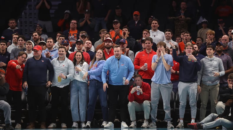 Fans cheer during a game between Dayton and Virginia on Saturday, Dec. 6, 2025, at the Spectrum Center in Charlotte, N.C. David Jablonski/Staff