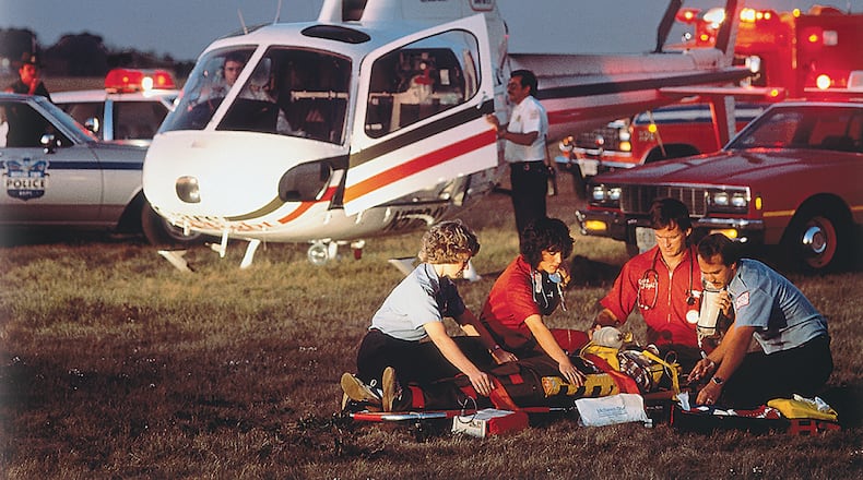 Candy Skidmore and other members of CareFlight respond to the scene of an accident in 1983, when the CareFlight program began. Skidmore has been with CareFlight since its inception, starting as a flight nurse before becoming an administrator of the program. Skidmore has also been Premier Health’s vice president of emergency and trauma services for over the last decade. COURTESY OF PREMIER HEALTH