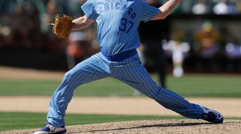 Chicago Cubs pitcher Travis Wood works against the Oakland Athletics in the ninth inning of a baseball game Saturday, Aug. 6, 2016, in Oakland, Calif. (AP Photo/Ben Margot)