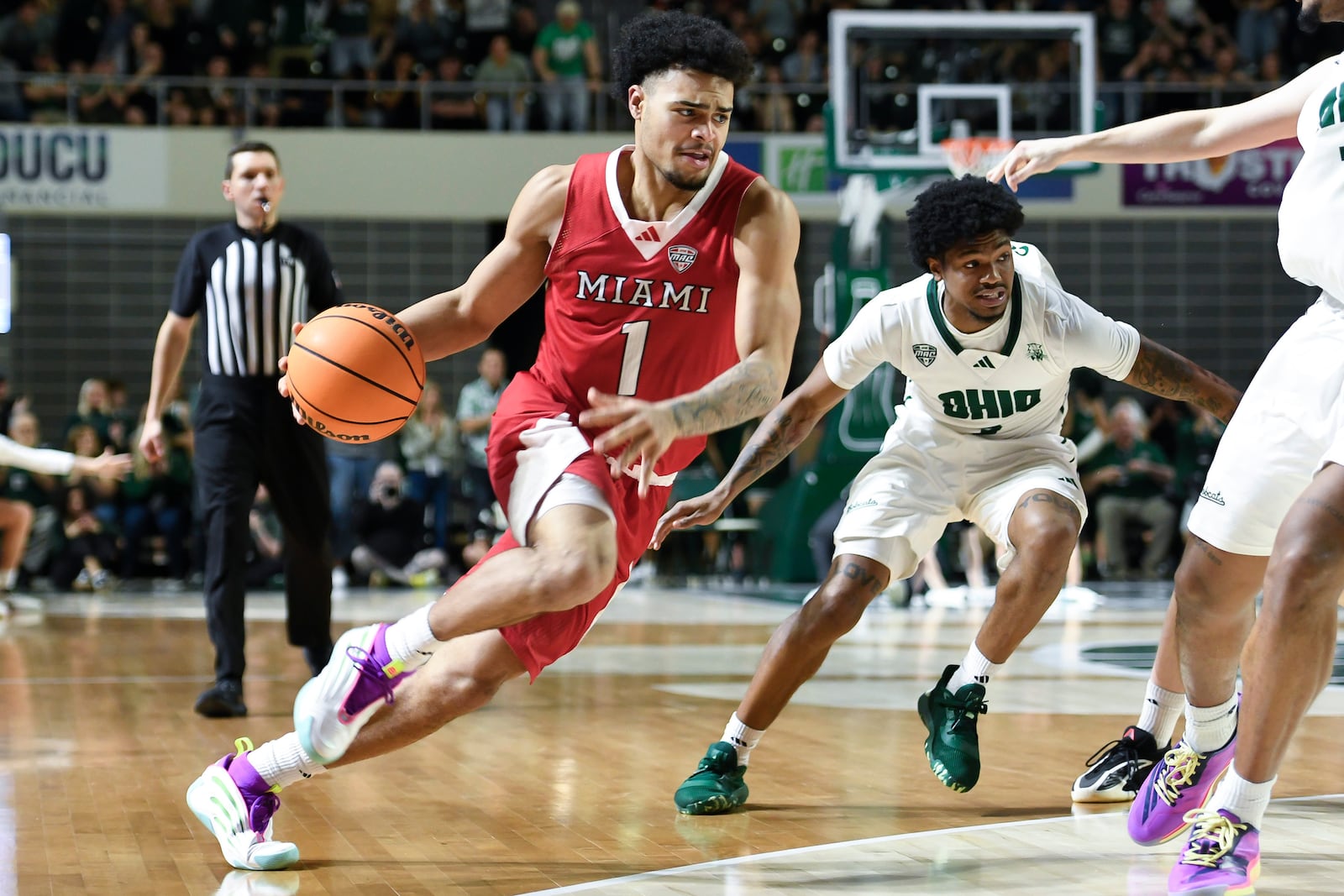 Miami (Ohio) guard Trey Perry (1) drives to the basket during the second half of an NCAA college basketball game against Ohio, Friday, March 6, 2026, in Athens, Ohio. (AP Photo/HG Biggs)