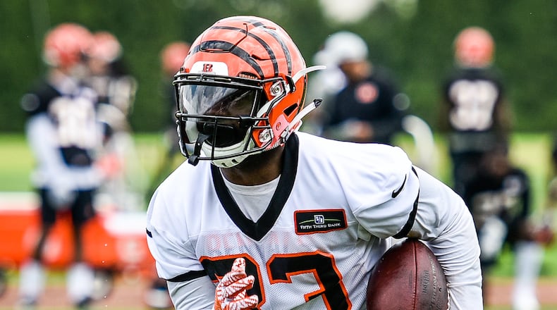 Bengals’ running back Tra Carson carries the ball during organized team activities Tuesday, May 22 at the practice facility near Paul Brown Stadium in Cincinnati. NICK GRAHAM/STAFF