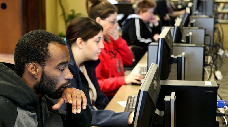 Jacob Brown, 23, (left) searches for jobs at the Lane Library Hamilton branch. In 2013, about 72 percent of Ohio residents had high-speed broadband service at home, up 1 percentage point from 2012 and 6 percentage points from 2011, according to a survey of Connect Ohio. About 12 percent of Ohioans last year did not use the Internet, and others have slow, dial-up service or can only access the web outside of home, the survey found.