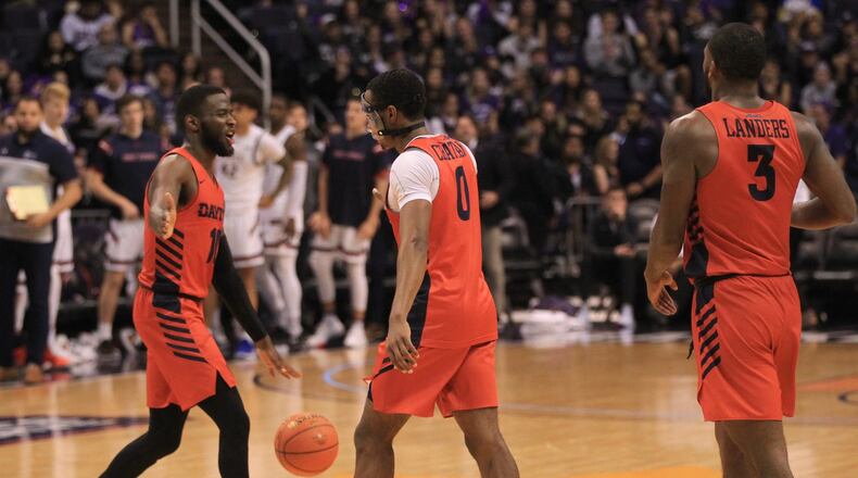 Dayton players (left to right) Jalen Crutcher, Rodney Chatman and Trey Landers react after a victory against Saint Mary’s on Sunday, Dec. 8, 2019, at Talking Stick Resort Arena in Phoenix, Ariz. David Jablonski/Staff