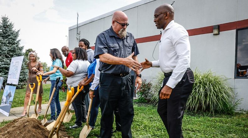 Director of Transportation Fleet Maintenance for Dayton Public Schools David Beard, left and Interim Dayton Public Schools superintendent David Lawrence celebrate after the groundbreaking of the new Jackson Center on James H. McGee Blvd. Friday August 11, 2023. JIM NOELKER/STAFF