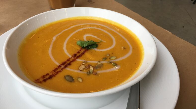 A pumpkin soup ($4 for a cup, $6 for a bowl) from Table 33, made with roasted organic pumpkin, red pepper, coconut milk topped with honey cinnamon coconut cream, cilantro and toasted pumpkin seeds has a refreshing Thai kick to it. The latte in the background was also a nice way to warm up. ALEXIS LARSEN/CONTRIBUTED