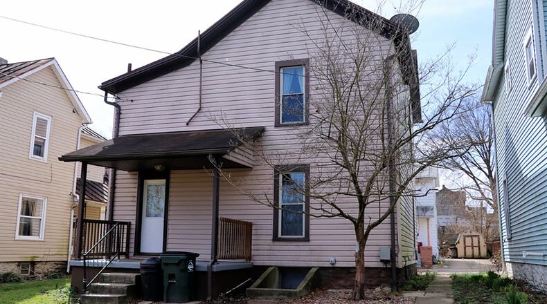 A covered rear porch is accessible from the step-saver kitchen. The basement is unfinished but has outside walk-out access. The house has updated carpeting, refinished wood floors, vinyl windows and vinyl siding.