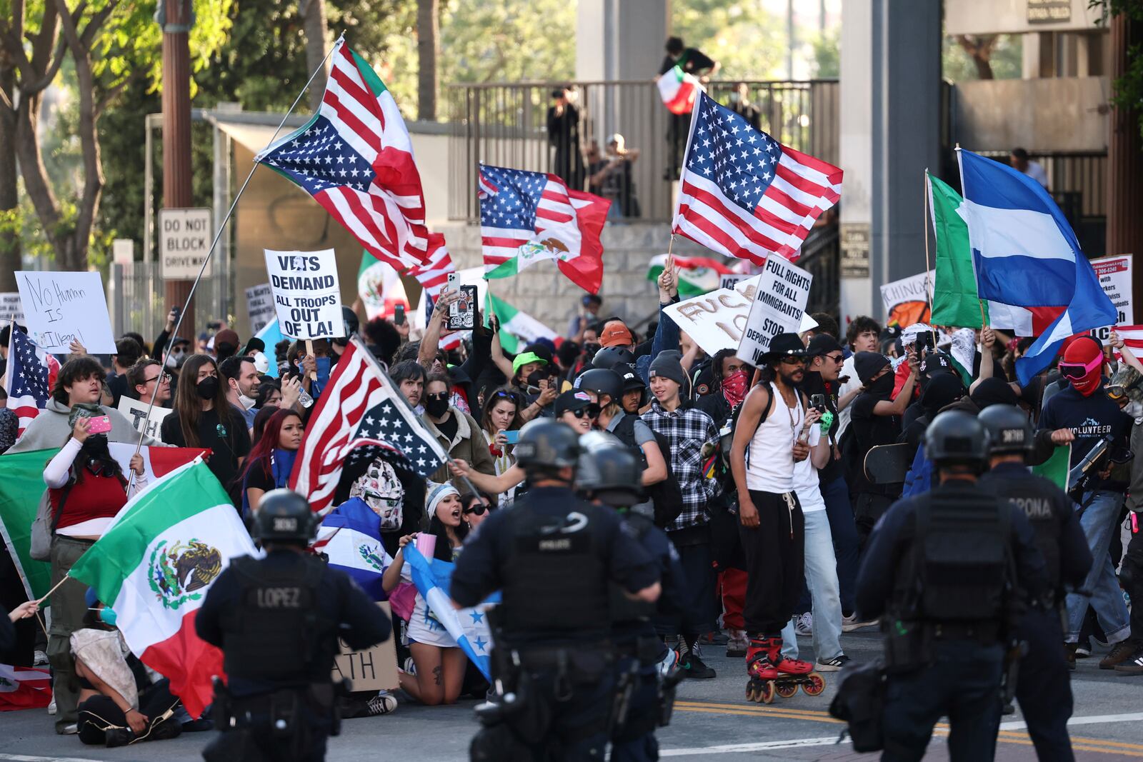 Law enforcement officers stand guard as demonstrators protest on Wednesday, June 11, 2025, in Los Angeles. (AP Photo/Ethan Swope)