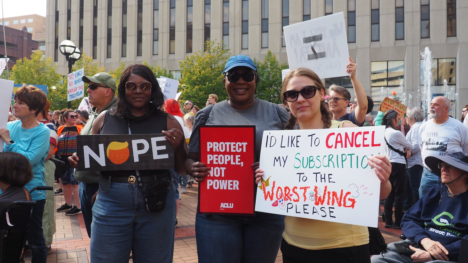 Frances Igah, 34, Flora Igah, 39 and Jessica Williams, 36, attended the "No Kings" Protest on Saturday, Oct. 18, 2025 at Courthouse Square in downtown Dayton. BRYN DIPPOLD/STAFF
