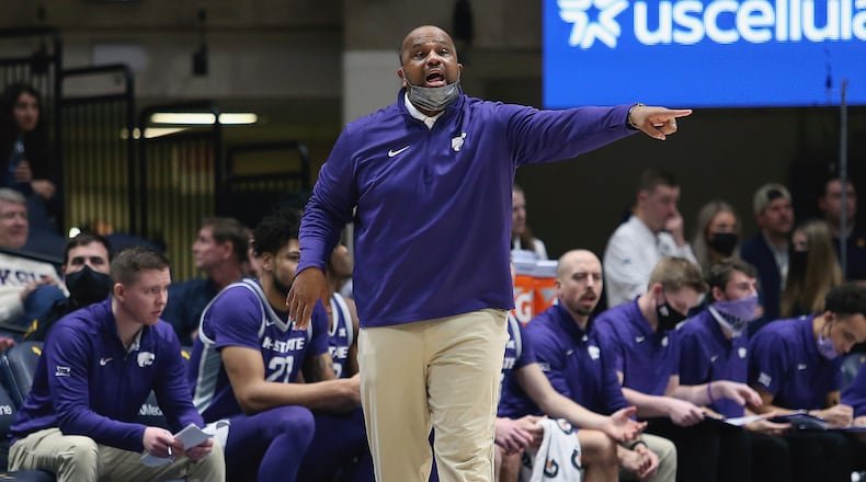 Kansas State assistant coach Jermaine Henderson reacts during the second half of an NCAA college basketball game against West Virginia in Morgantown, W.Va., Saturday, Jan. 8, 2022. (AP Photo/Kathleen Batten)