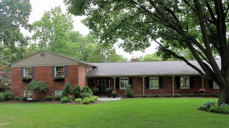 Listed for $750,000 by Coldwell Banker Heritage, this brick tri-level at 5001 James Hill Road has about 4,217-square feet of living space. Nestled among mature trees on a corner lot, the property has island gardens, stone walkways and a spacious paver patio with a wood-burning fireplace. KATHY TYLER/CONTRIBUTED