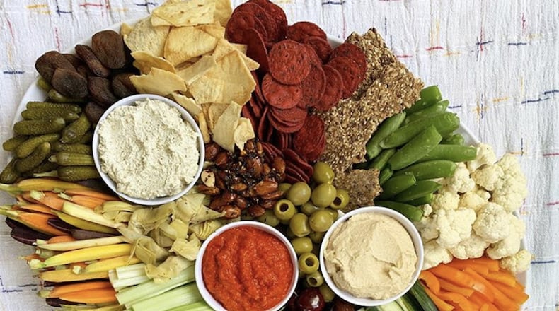 FILE: A charcuterie board is literally the easiest thing to throw together and, when done right, makes a gorgeous and delectable centerpiece. Pick 3 different kinds of cheese, three different meats, grab some figs, a handful of grapes, a few rosemary sprigs and you are in business. CONTRIBUTED BY KAITLIN SKILKEN