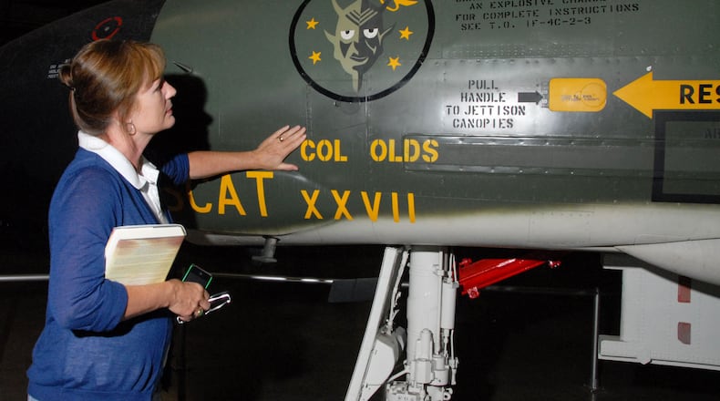 Christina Olds, daughter of the late triple ace and Air Force Cross recipient Brig. Gen. Robin Olds, touches her father's F-4C Phantom II at the National Museum of the U.S. Air Force. (U.S. Air Force Photo)