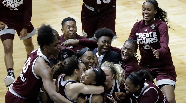 Mississippi State guard Morgan William, center, celebrates with teammates after she hit the winning shot at the buzzer in overtime to defeat Connecticut in an NCAA college basketball game in the semifinals of the women’s Final Four, Friday, March 31, 2017, in Dallas. Mississippi State won 66-64. (AP Photo/Eric Gay)