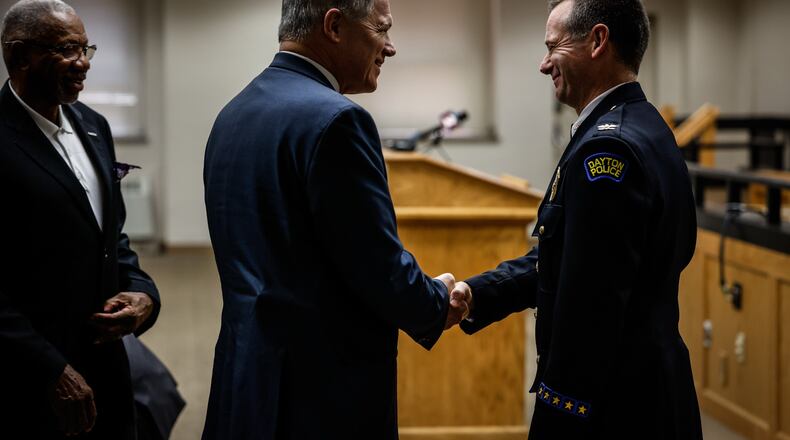 Retired Dayton police chief Richard Biehl attends the swearing-in of interim Dayton director and chief of police Matt Carper Friday July 30, 2021, at Dayton City Hall. City Commissioner, Jeffrey Mims is on the left. JIM NOELKER/STAFF