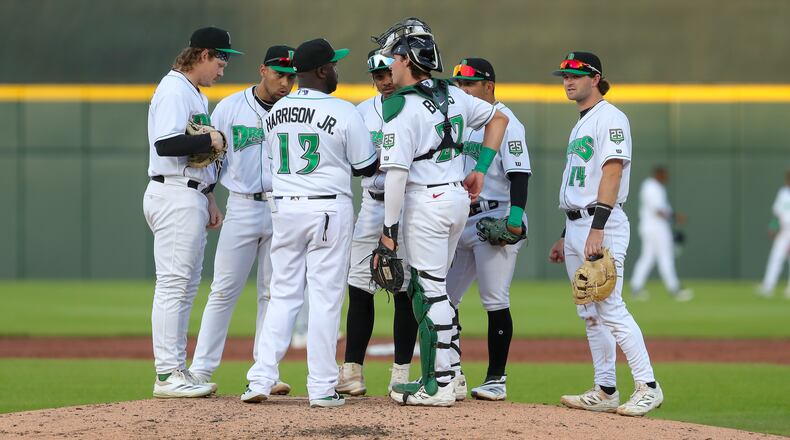 Dayton Dragons manager Vince Harrison, Jr. talks with his players during a mound visit during their game against the West Michigan Whitecaps on Tuesday, April 22 at Day Air Ballpark. Michael Cooper/STAFF