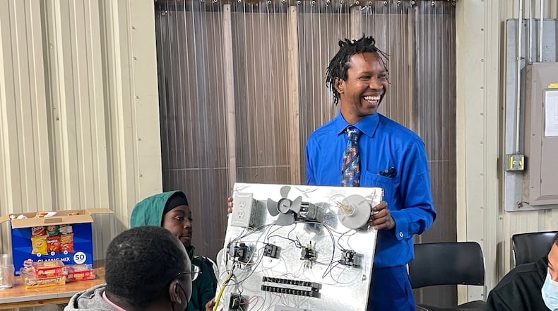 Charles Williams IV demonstrates the skills he learned during the Dayton Urban Ministry Foundation's HVAC training program. AIMEE HANCOCK / STAFF