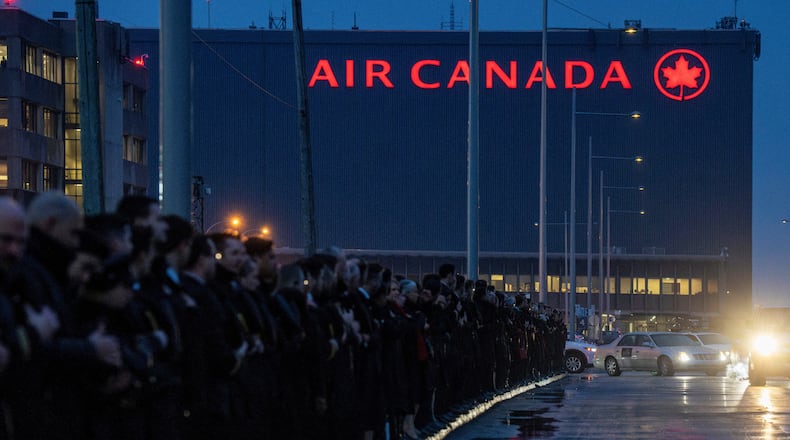 A procession for Air Canada Jazz pilot Antoine Forest, who died Sunday when his plane collided with an emergency vehicle at New York's LaGuardia Airport, leaves Air Canada headquarters, in Montreal, Thursday, March 26, 2026. (Christinne Muschi/The Canadian Press via AP)