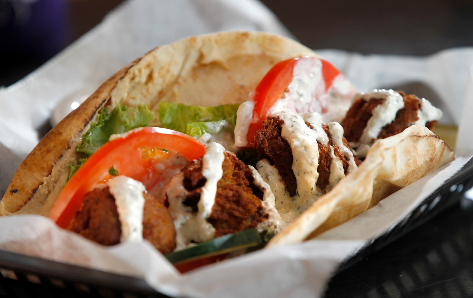 The Ultimate Falafel sandwich at Blind Bob's is made with four croquettes of house made flavel wrapped in a fresh pitta with house hummus, lettuce, tomato, cucumber and tzatziki sauce. LISA POWELL / STAFF