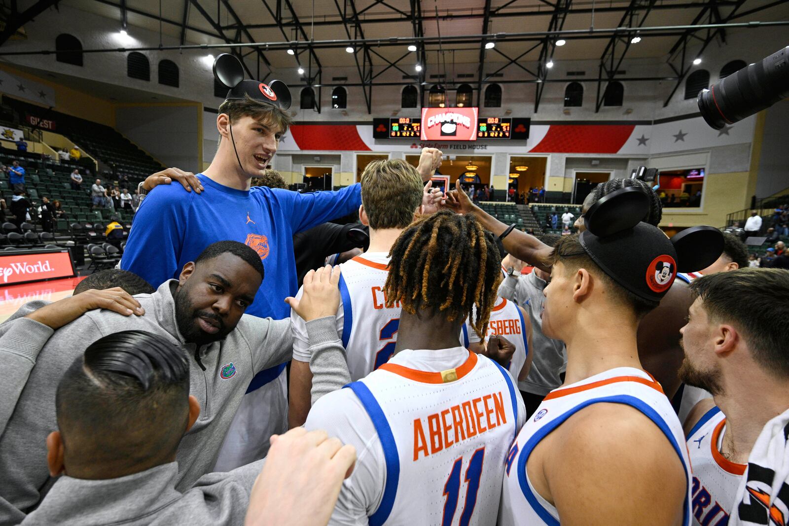 FILE - Florida center Olivier Rioux, upper left, huddles with teammates on the court after an NCAA college basketball game against Wichita State, Friday, Nov. 29, 2024, in Kissimmee, Fla. (AP Photo/Phelan M. Ebenhack, File)
